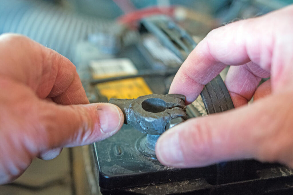 Close-up of a mechanic's hands assessing the condition of a used piece of machinery