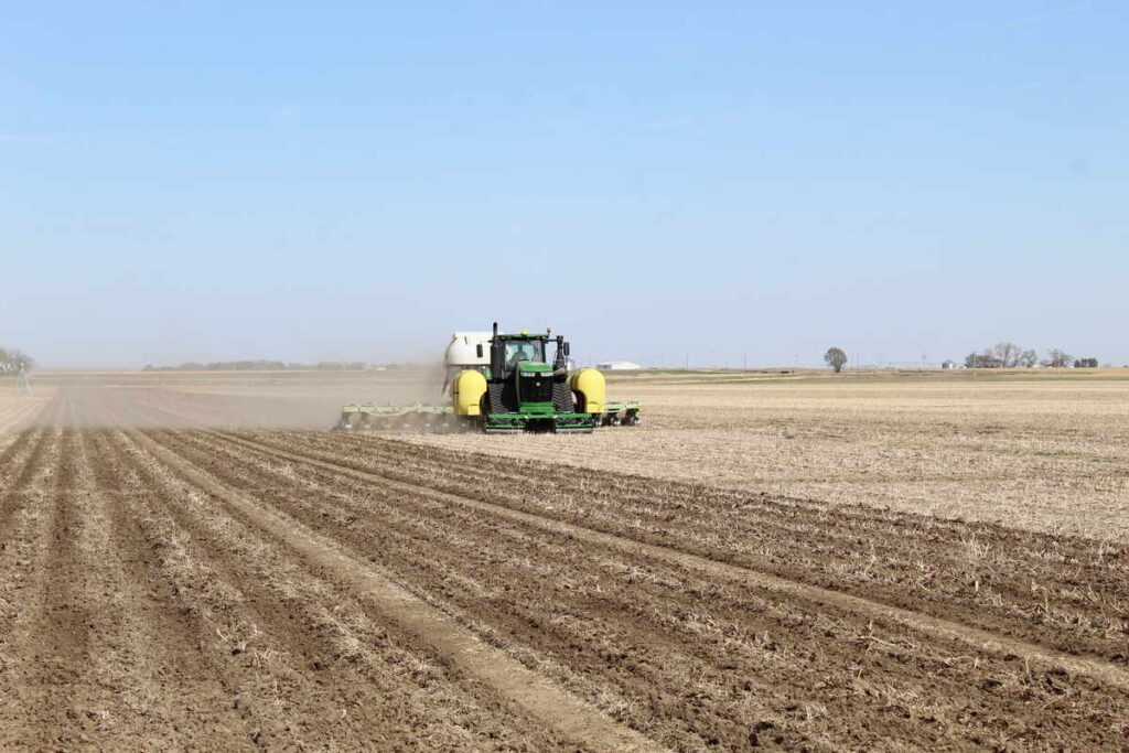 Tractor ready for winterizing on a barren corn field