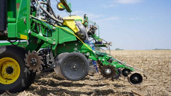 10 essential preseason planter checks for better yields blog header image showing tractor in a field