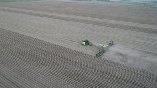 Planter machine on open crop field